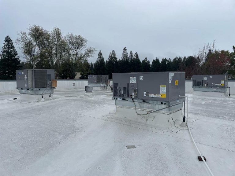 Carrier commercial rooftop package units installed on a flat roof in Tracy CA.