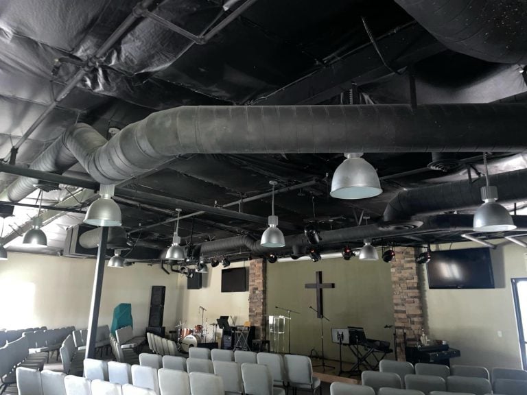 Commercial overhead ductwork installed in a church auditorium.