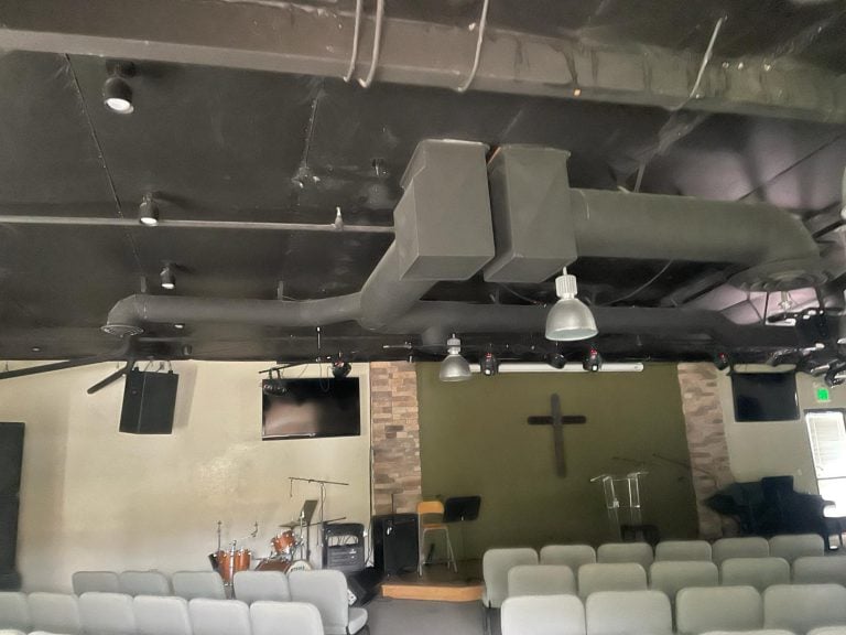 Commercial overhead ductwork installed in a church auditorium.