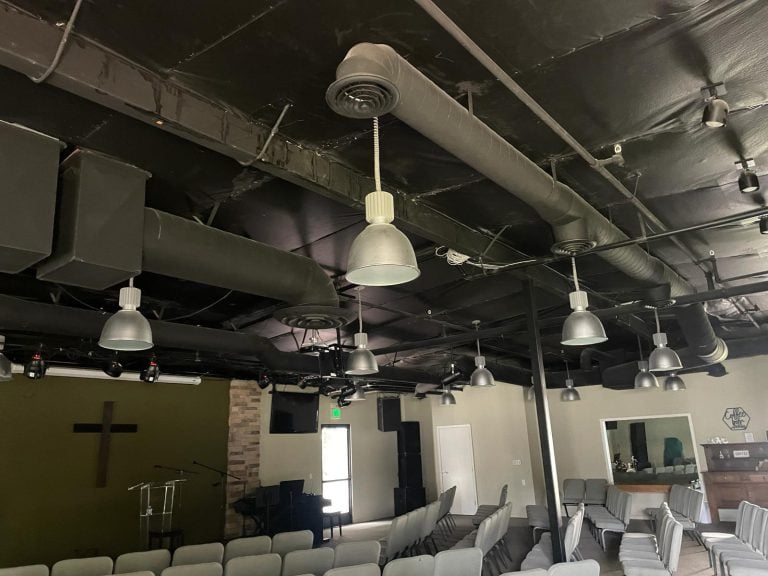 Commercial spiral ductwork installed in a church auditorium ceiling.
