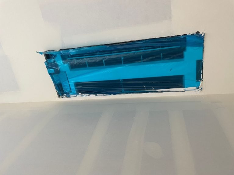 Newly installed mini split unit still wrapped in protective film.