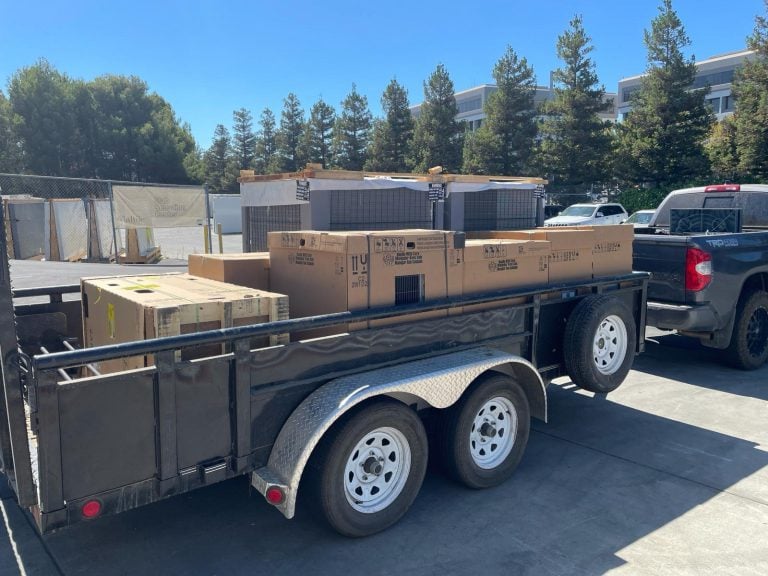 New HVAC equipment loaded on a trailer for delivery to a job site.